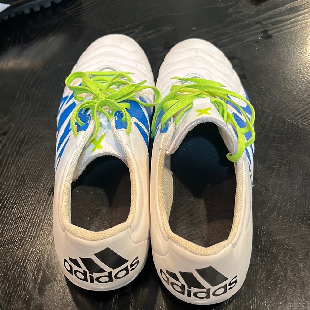 Men’s white and blue adidas indoor soccer cleats.